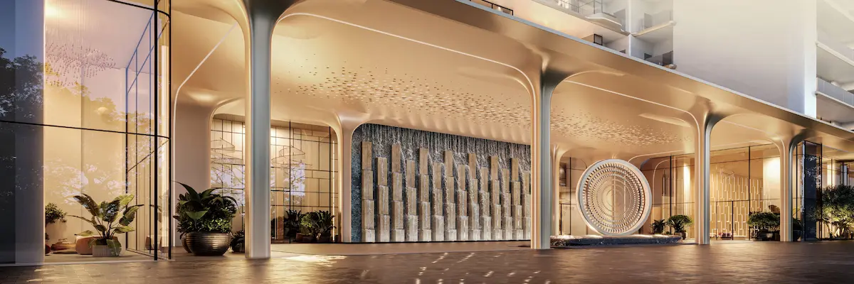 Grand luxury entrance and drop-off area at Smartworld Elie Saab residences featuring a cascading water wall and bespoke circular sculpture